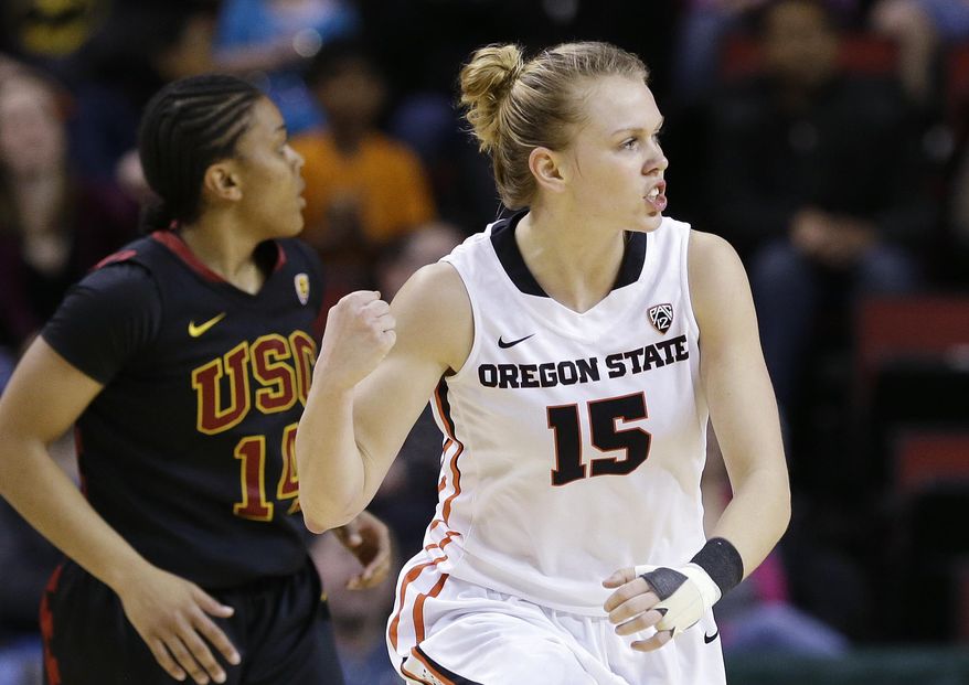 Oregon State's Jamie Weisner (15) pumps her fist after scoring as Southern California's Ariya Crook trails in the first half of the Pac-12 NCAA college championship basketball game Sunday, March 9, 2014, in Seattle. (AP Photo/Elaine Thompson)
