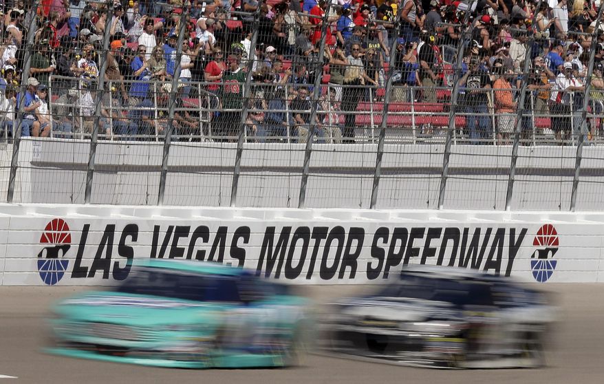 Drivers head into Turn 1 on the fourth lap of a NASCAR Sprint Cup Series auto race on Sunday, March 9, 2014, in Las Vegas. (AP Photo/Julie Jacobson)