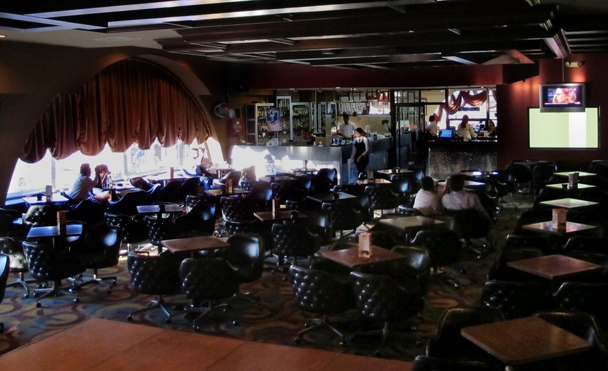 Costumers sit at an almost empty bar in Matamoros, Mexico, Friday, Feb. 28, 2014. In the midst of a three-year increase in American tourism in Mexico, communities along the Rio Grande are trying to win back U.S. tourists and revitalize their tourism industry. (AP Photo/Olga Rodriguez)