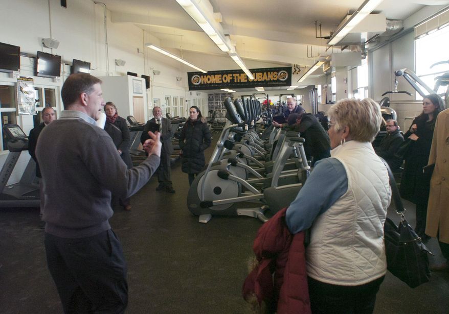In this Feb. 26, 20-14 photo Cuba City principal Jim Boebel gives a tour to lawmakers on a committee that looked at money issues in Wisconsin’s rural schools at Cubs City High School in Cuba City, Wis. Boebel told the Rural Schools Task Force a $750,000 federal grant helped build a state of the art fitness center that is open to the community members after hours. (AP Photo/Taylor Anderson)