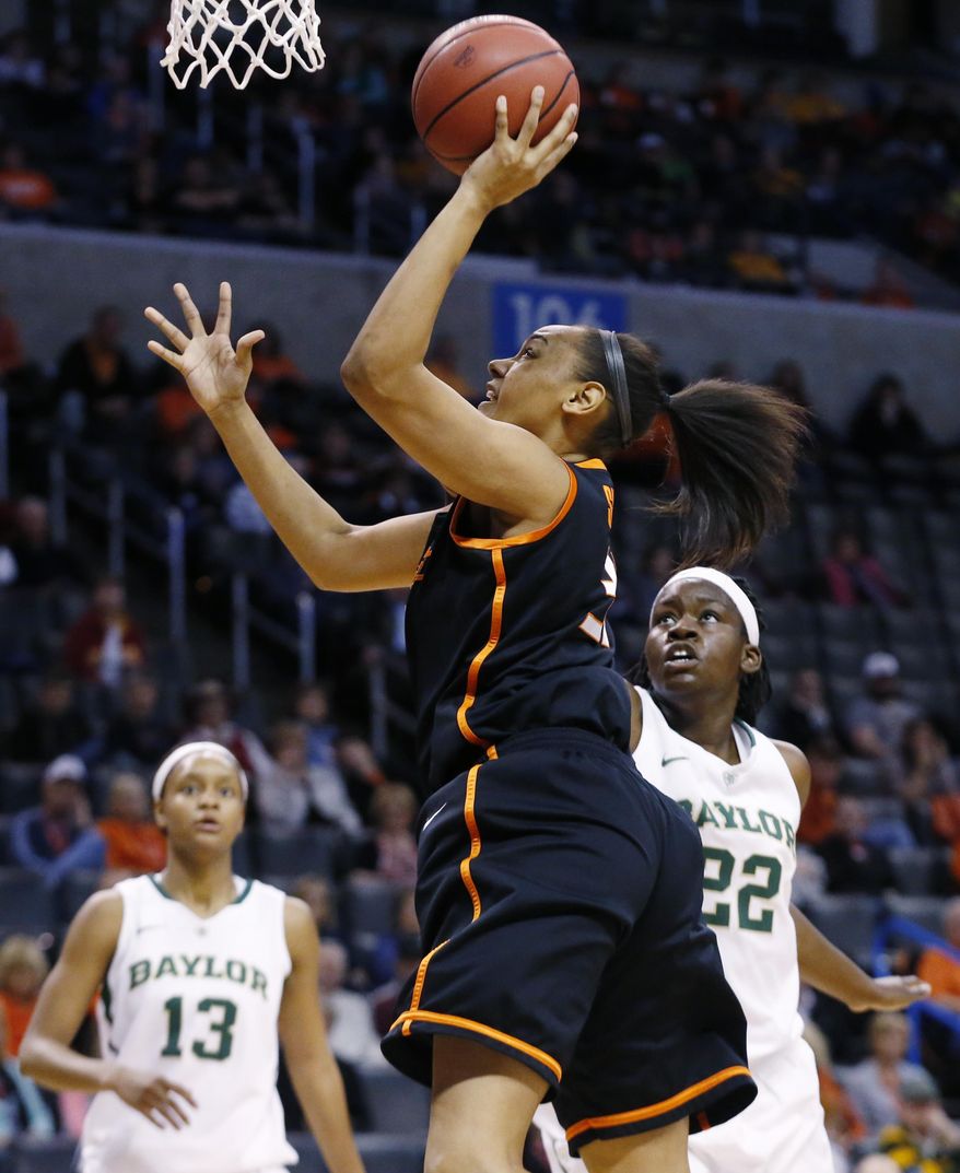 Oklahoma State center Kendra Suttles, center, shoots in front of Baylor forward Nina Davis (13) and point Sune Agbuke (22) in the first half of an NCAA college basketball game in the semifinals of the Big 12 Conference women's college tournament in Oklahoma City, Sunday, March 9, 2014. Baylor won 65-61. (AP Photo/Sue Ogrocki)