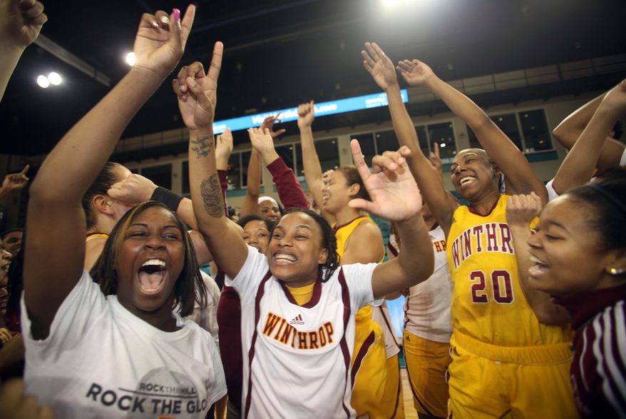 Winthrop Eagles basketball team celebrates beating High Point at the Big South Conference chanpionship 87-74 at a NCAA college basketball in Conway, S.C. on, Sunday, March 9, 2014. (AP Photo/Willis Glassgow)
