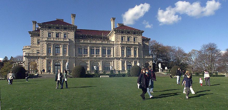 FILE - In this Nov. 12, 2001 file photo, visitors take advantage of free admission to tour The Breakers mansion in Newport, R.I. Neighbors of The Breakers estate in Newport are suing to block a new welcome center that's planned for the site of the mansion, built in the Gilded Age by the Vanderbilts, then one of the nation's most prominent and wealthy families. The neighborhood association filed the lawsuit Friday, March 7, 2014 in Newport Superior Court against the Preservation Society of Newport County, which owns several mansions in this seaside tourist town, operating them as museums. The 70-room Breakers, a national historic landmark, is its crown jewel and draws 400,000 visitors annually. The group wants to build the center on the 13-acre grounds of the mansion to provide visitors with services, including ticketing, accessible restrooms and prepared sandwiches.(AP Photo/Stew Milne, File)