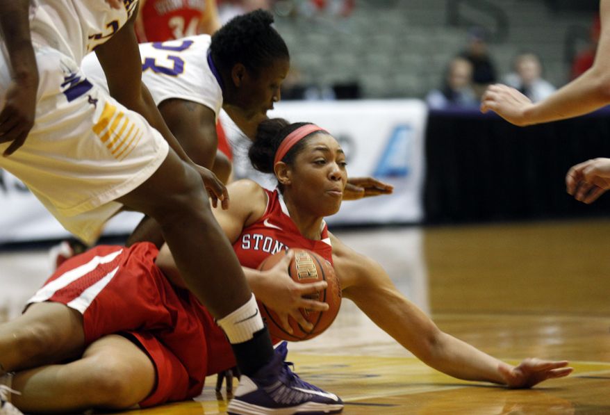 Stony Brook forward Sabre Proctor (13) grabs the loose ball in front of Albany defenders during the first half of an NCAA America East college championship basketball game on Monday, March 10, 2014, in Albany, N.Y. (AP Photo/Mike Groll)