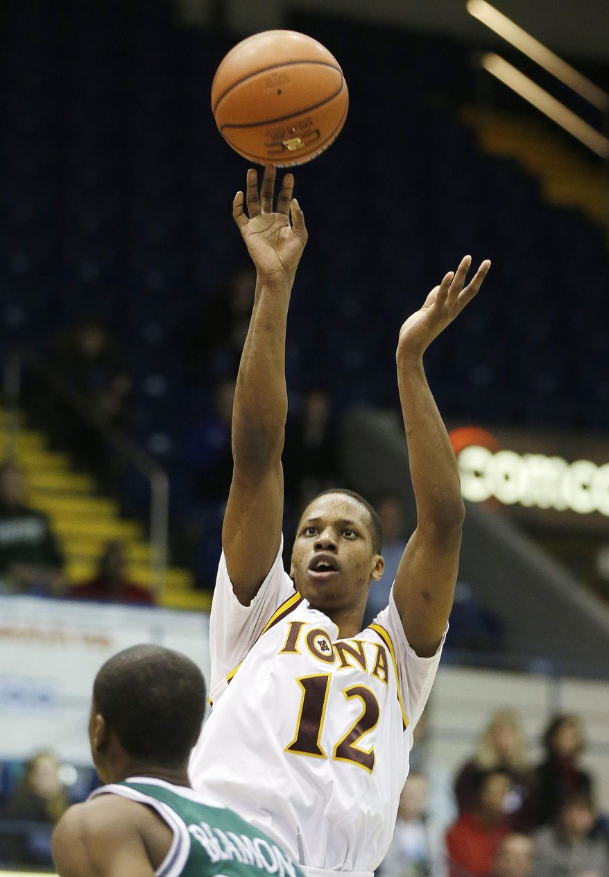 Iona guard Mike Poole (12) shoots over Manhattan guard George Beamon during the first half of an NCAA men's MAAC conference championship tournament basketball finals game in Springfield, Mass., Monday, March 10, 2014. (AP Photo/Stephan Savoia)