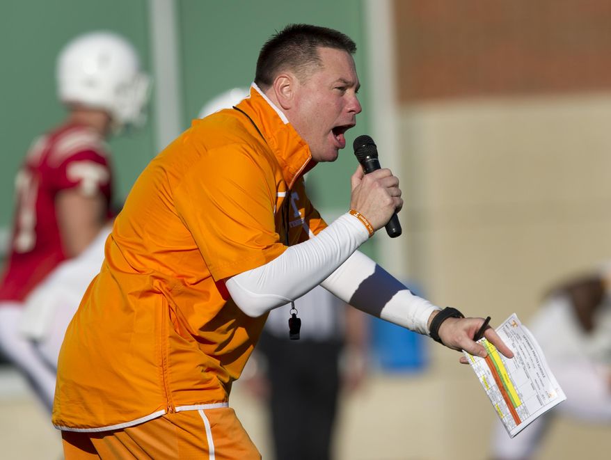 Tennessee coach Butch Jones gives instruction during the team's first spring NCAA college football practice on Friday, March 7, 2014, in Knoxville, Tenn. (AP Photo/Knoxville News Sentinel, Paul Efird)