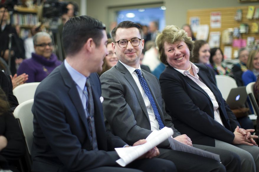 Thomas Rimbey Ogletree, center, smiles at his partner Nicholas Haddad, left, during a news conference following the announcement that a case against his father Rev. Thomas Ogletree for breaking church law by officiating their same-sex marriage had been dropped, Monday, March 10, 2014, in White Plains, N.Y. Bishop Martin McLee, who announced the decision, called on church officials to stop prosecuting other pastors for marrying same-sex couples. McLee, who leads the church's New York district said he would cease church trials over the issue in his district and would organize a broad discussion about the church's internal divisions over gay relationships. (AP Photo/John Minchillo)