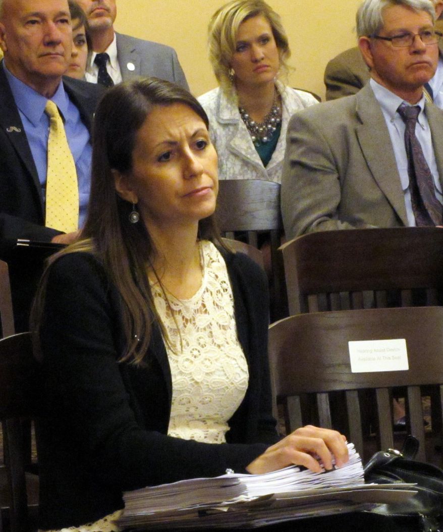 Kansas House Education Committee Chairwoman Kasha Kelley, an Arkansas City Republican, follows a briefing for House Republicans on a recent Kansas Supreme Court decision on school funding, Monday, March 10, 2014, at the Statehouse in Topeka, Kan. The decision says the state must boost aid to poor school districts. (AP Photo/John Hanna)