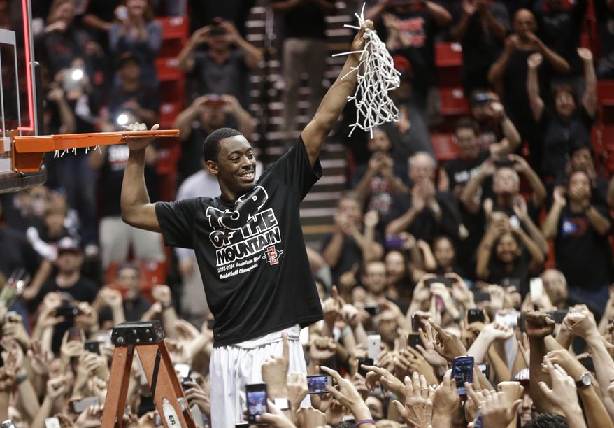 San Diego State's Xavier Thames holds up a cut net after San Diego State defeated New Mexico 51-48 to win the Mountain West Conference title, in an NCAA college basketball game Saturday, March 8, 2014, in San Diego. (AP Photo/Lenny Ignelzi)