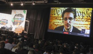 Edward Snowden talks during a simulcast conversation during the SXSW Interactive Festival on Monday, March 10, 2014, in Austin, Texas. Snowden talked with American Civil Liberties Union’s principal technologist Christopher Soghoian, and answered tweeted questions. (Photo by Jack Plunkett/Invision/AP)