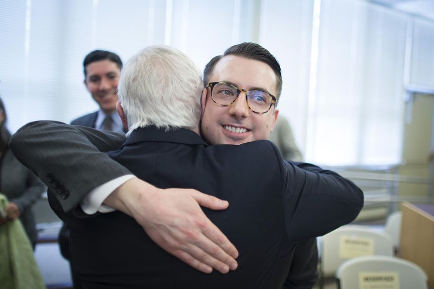 Thomas Rimbey Ogletree, center right, hugs his father Rev. Thomas Ogletree following a news conference to announce that a case against the Thomas Ogletree for breaking church law by officiating his son's same-sex marriage had been dropped, Monday, March 10, 2014, in White Plains, N.Y. Bishop Martin McLee, who announced the decision, called on church officials to stop prosecuting other pastors for marrying same-sex couples. McLee, who leads the church's New York district said he would cease church trials over the issue in his district and would organize a broad discussion about the church's internal divisions over gay relationships. (AP Photo/John Minchillo)