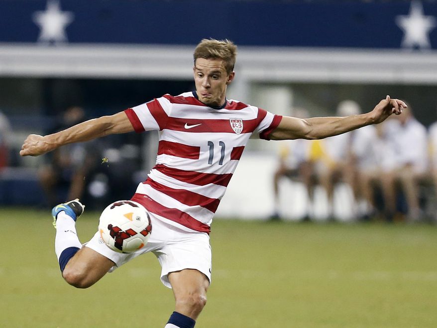 FILE - In this July 24, 2013, file photo, United States' Stuart Holden (11) attempts a shot on goal during a Gold Cup semifinal against Honduras in Arlington, Texas. Holden has undergone another operation to repair ligaments in his right knee and will be sidelined for six-to-nine months. Bolton, Holden's club in England's second-tier League Championship, made the announcement Tuesday, March 11, 2014, eight days after the 28-year-old lasted less than a half-hour with the Bolton under-21 team against Everton. (AP Photo/Brandon Wade, File)