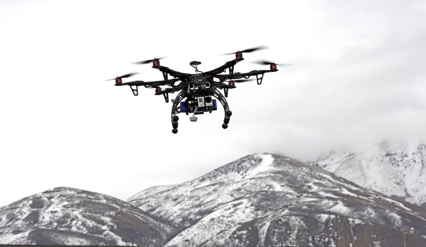 In this Feb. 13, 2014, photo, members of the Box Elder County Sheriff's Office fly their search and rescue drone during a demonstration, in Brigham City, Utah. Law enforcement, government agencies and others are itching to use drones for everything from finding lost hikers to tracking shifting wildfires. But privacy watchdogs are urging state legislatures to step in and head off any potential privacy violations. That tension is on display as more than 35 states consider drone legislation this year, according to the National Conference of State Legislatures. The bills include ways to attract an industry that could generate billions and restrictions on drone use and data collection. (AP Photo/Rick Bowmer)