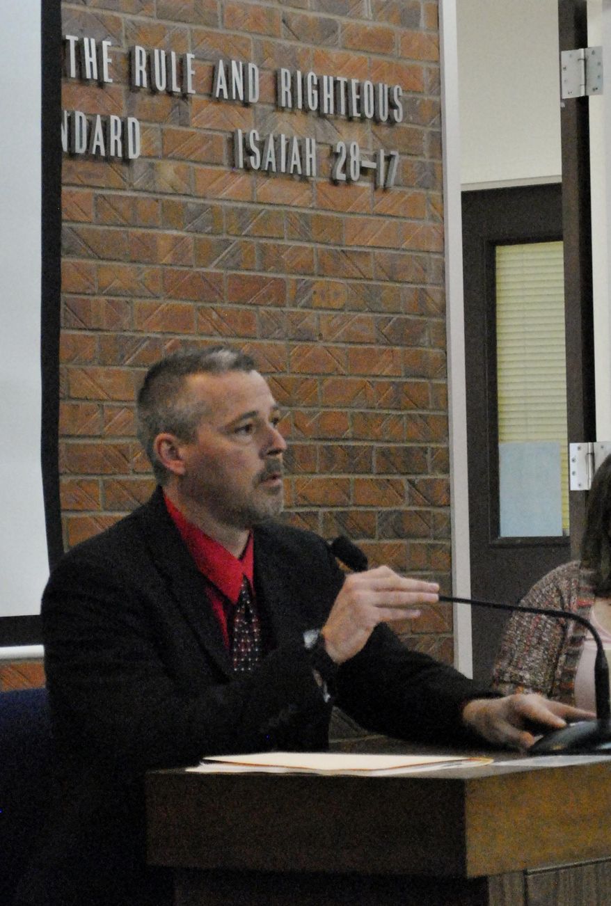 Det. Jeremi Thompson, with the Franklin County Sheriff's Office, testifies during a hearing in Kyle Flack's capital murder trial in Franklin County District Court Tuesday, March 11, 2014, in Ottawa, Kan. Flack, 28, is charged with capital murder and other charges in the slaying of of Andrew Stout, Steven White and Kaylie Bailey, including Bailey's 18-month-old daughter, at a farm in rural eastern Kansas last spring. (AP Photo/The Ottawa Herald, Abby Eckel, Pool)