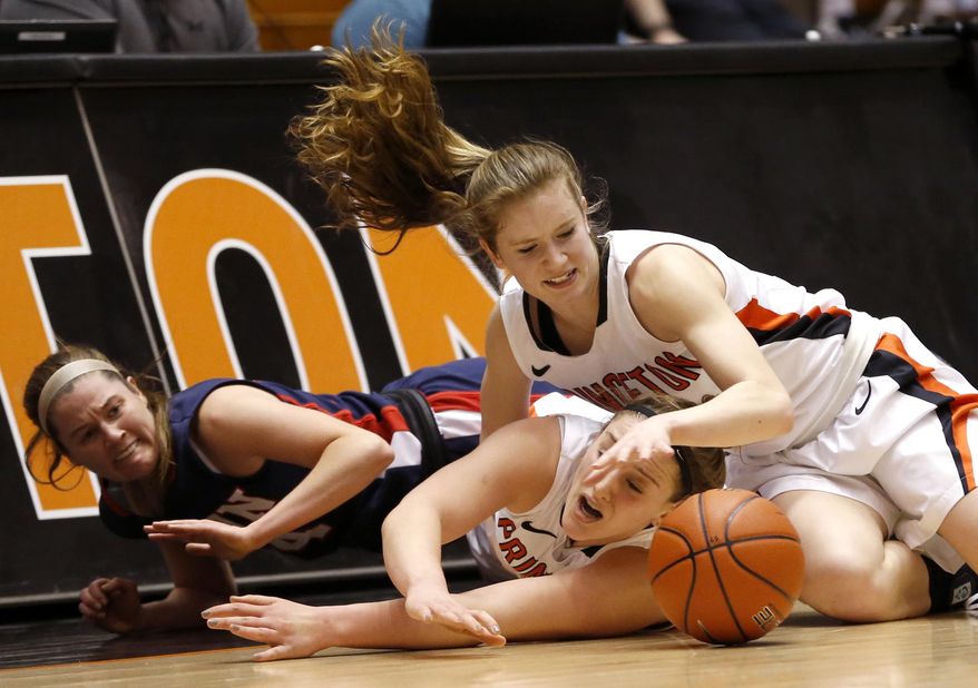 Penn guard Meghan McCullough, left, collides with Princeton guards Annie Tarakchian, center, and Blake Dietrick while competing for the ball during the first half of an NCAA college basketball game, Tuesday, March 11, 2014, in Princeton, N.J. (AP Photo/Julio Cortez)