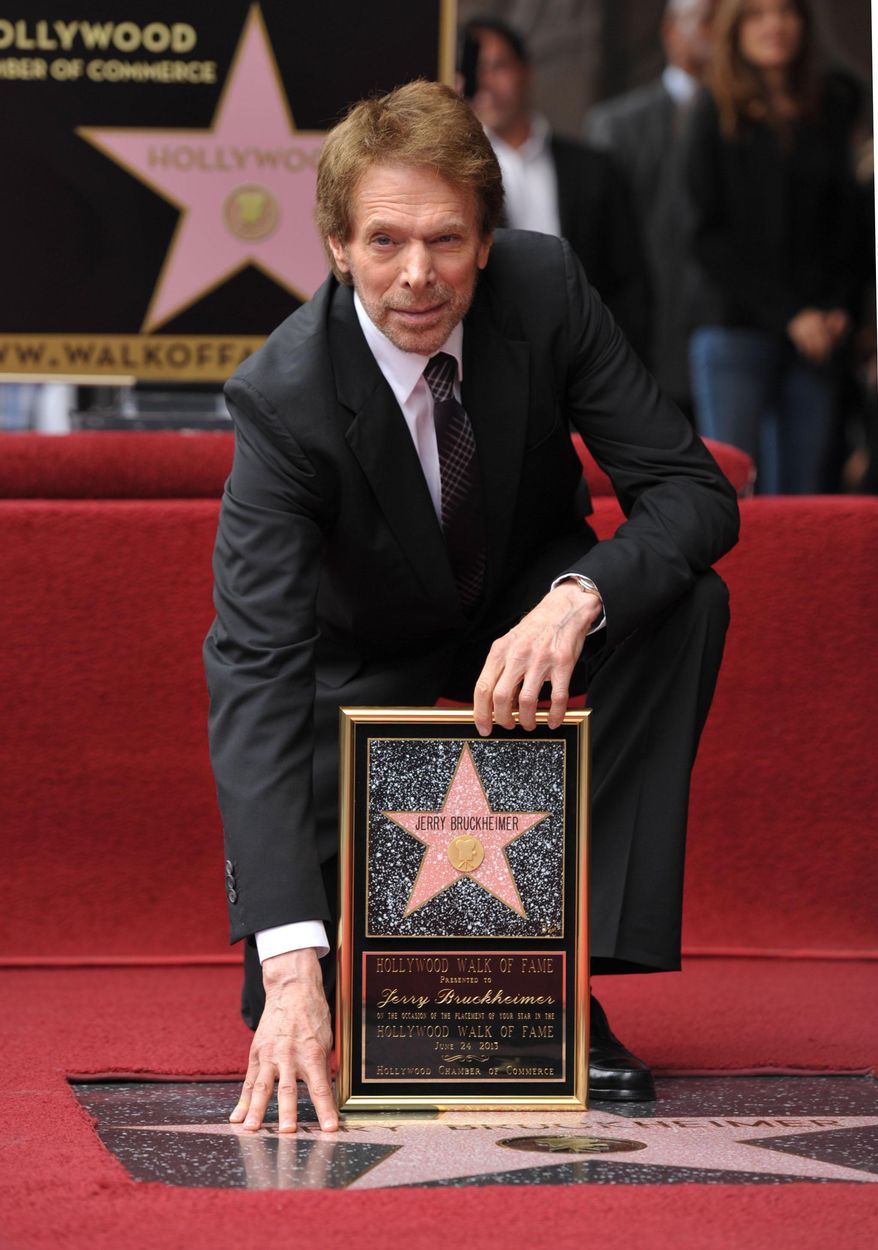 In this June 24, 2013 file photo, film producer Jerry Bruckheimer poses with his star on the Hollywood Walk of Fame in Los Angeles. After more than two decades with Disney, where he produced the juggernaut “Pirates of the Caribbean” and “National Treasure” film franchises among many box-office hits, Bruckheimer begins a new partnership with Paramount in March 2014. Bruckheimer continues his work in television, too, where he’s found groundbreaking success with the many “CSI” series and “The Amazing Race,” which has won 14 Emmy Awards.  (Photo by John Shearer/Invision/AP, File)