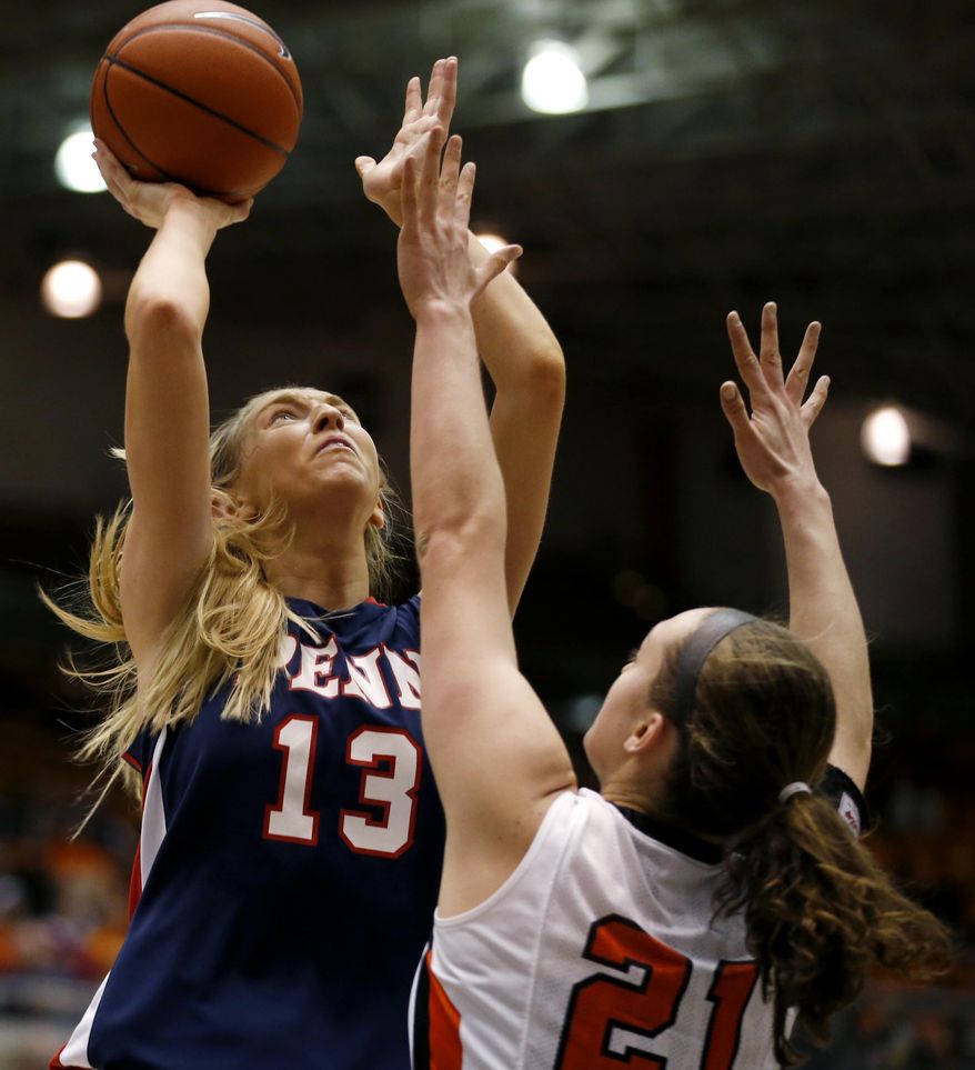 Penn center Sydney Stipanovich (13) shoots against Princeton forward Alex Wheatley (21) during the first half of an NCAA college basketball game, Tuesday, March 11, 2014, in Princeton, N.J. (AP Photo/Julio Cortez)