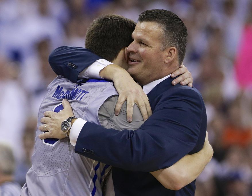 Creighton coach Greg McDermott hugs his son, Doug McDermott (3) after Doug scored his 3000th career point in the second half on an NCAA college basketball game in Omaha, Neb., Saturday, March 8, 2014. Doug McDermott scored a career-high 45 points and became the eighth player in Division I history to go over 3,000 for a career, and No. 13 Creighton rolled to an 88-73 victory over Providence on Saturday night. (AP Photo/Nati Harnik)