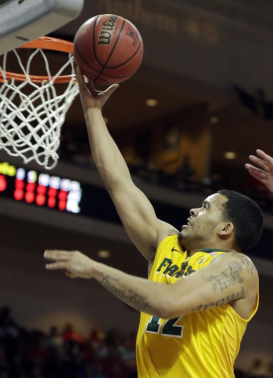 San Francisco's Avry Holmes shoots during the first half of a West Coast Conference tournament NCAA college basketball game against BYU Monday, March 10, 2014, in Las Vegas. (AP Photo/Isaac Brekken)