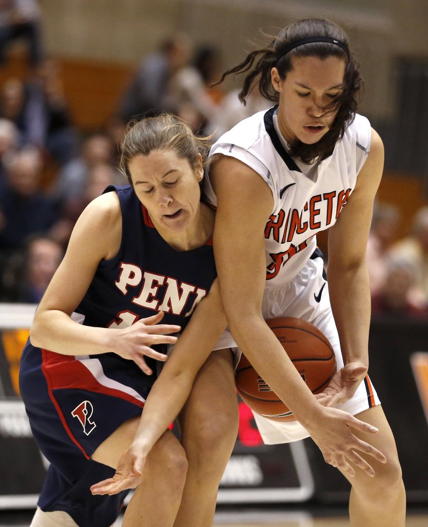 Penn guard Meghan McCullough, left, and Princeton forward Kristen Helmstetter compete for the ball during the first half of an NCAA college basketball game, Tuesday, March 11, 2014, in Princeton, N.J. (AP Photo/Julio Cortez)