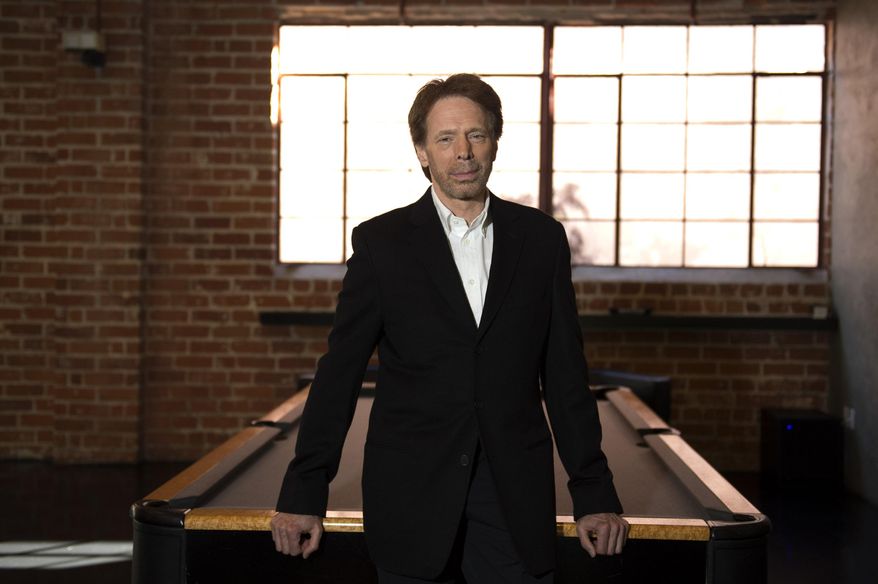 In this Monday, Jan. 13, 2014 photo, Jerry Bruckheimer poses for a portrait at his office in Santa Monica, Calif.  After more than two decades with Disney, where he produced the juggernaut “Pirates of the Caribbean” and “National Treasure” film franchises among many box-office hits, Bruckheimer begins a new partnership with Paramount in March 2014. At Disney’s behest, he closes his previous chapter with a photo book as outsized as some of his productions: “Jerry Bruckheimer: When Lightning Strikes - Four Decades of Filmmaking” is a 10-pound, 300-page chronicle of his career in pictures. (Photo by Jordan Strauss/Invision/AP)
