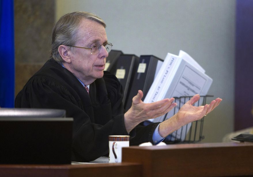 Judge Kenneth Cory speaks to attorneys during a hearing at the Regional Justice Center in Las Vegas, Tuesday, March 11, 2014. The judge kept a temporary restraining order in place preventing an Animal Foundation raffle of puppies rescued in a Jan. 27 fire at the Prince and Princess Pet Shop. An evidentiary hearing is scheduled for March 19. (AP Photo/Las Vegas Sun, Steve Marcus)