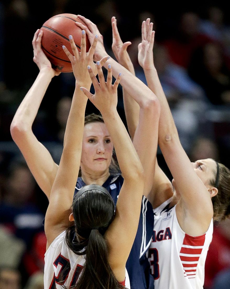 BYU's Jennifer Hamson, center, is double teamed by Gonzaga's Keani Albanez, left, and Kiara Kudron in the first half of an NCAA West Coast Conference women's tournament championship college basketball game, Tuesday, March 11, 2014, in Las Vegas. (AP Photo/Julie Jacobson)