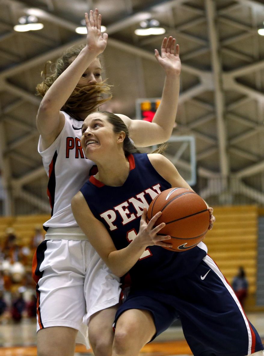 Penn guard Meghan McCullough, right, drives against Princeton guard Blake Dietrick during the first half of an NCAA college basketball game, Tuesday, March 11, 2014, in Princeton, N.J. (AP Photo/Julio Cortez)