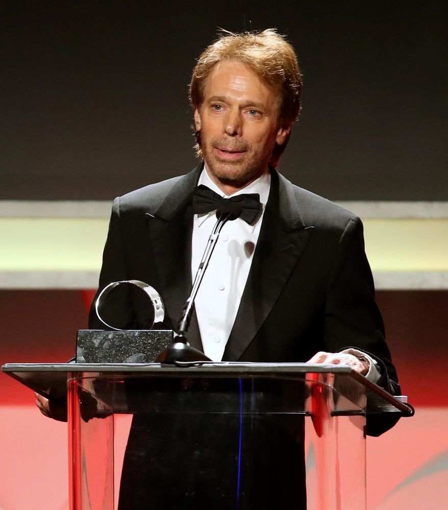 FILE- In this Dec. 12, 2013 file photo, producer Jerry Bruckheimer accepts the 27th Annual American Cinematheque Award on stage, in Beverly Hills, Calif. After more than two decades with Disney, where he produced the juggernaut “Pirates of the Caribbean” and “National Treasure” film franchises among many box-office hits, Bruckheimer begins a new partnership with Paramount in March 2014. Bruckheimer Films has 40 projects cooking at any one time; the TV division has at least 10 scripts in development. (Photo by Paul A. Hebert/Invision/AP, File)
