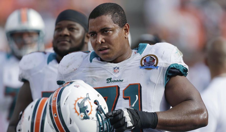 Miami Dolphins tackle Jonathan Martin (71) stands on the sidelines during the Dolphins&#x27; NFL football game against the Jacksonville Jaguars in Miami, Dec. 16, 2012. (AP Photo/Wilfredo Lee) ** FILE **