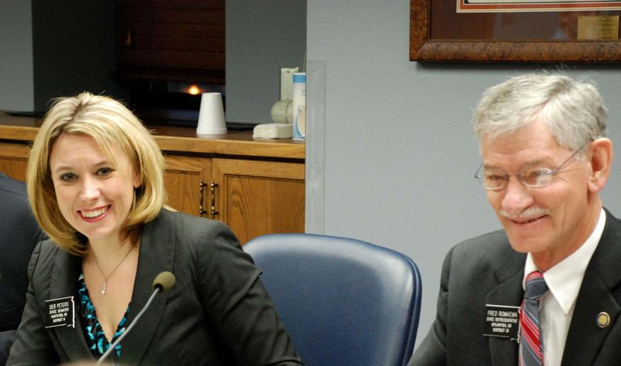 Senate Appropriations Chair Deb Peters, R-Hartford, left, and House Appropriations Chair Fred Romkema, R-Spearfish, speak Tuesday, March 11, 2014, during a meeting of the South Dakota Legislature's Joint Appropriations Committee in Pierre, S.D. The committee has adopted revenue estimates that exceed projections from state economists by several million dollars. The committee will use those estimates as it puts the finishing touches on next year's state budget this week. (AP Photo/Brokaw)