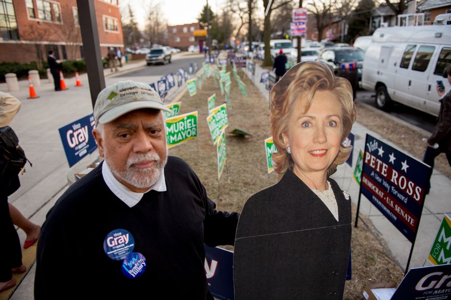 Grey campaign volunteer and Hilary Clinton supporter Arrington Dixon carries a life size cut out of Hilary Clinton as he waits for Washington, D.C. Mayor Vincent Gray to arrive to give his 2014 State of the District Address at Kelly Miller Middle School in Northeast a day after federal prosecutors accused Gray of knowing of and personally seeking illegal funs from Jeffrey Thompson do run an illegal &quot;Shadow Campaign&quot; during his run for mayor four years ago, Washington, D.C., Tuesday, March 11, 2014. (Andrew Harnik/The Washington Times)