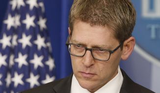 White House press secretary Jay Carney listens as he briefs reporters at the White House in Washington, Tuesday, March 11, 2014. Carney took questions about allegations that the CIA searched computers of congressional staffers. (AP Photo/Charles Dharapak)