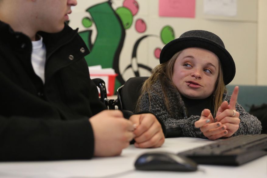 In this Feb. 13, 2014 photo, hip hop artist and Youth on Record teacher Kalyn Heffernan gestures while teaching a music composition class at Devereux Cleo Wallace, a residential youth treatment facility, in Denver. Founded by hip hop group the Flobots, Youth on Record recruits artists, trains them to teach, and puts instruments and professional recording equipment in the hands of young people. It reaches 700 students a year, and currently is working in four Denver high schools and two residential treatment centers. (AP Photo/Brennan Linsley)