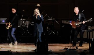 Singer Iggy Pop, center, performs with Bernard Sumner, right, and Tom Chapman from the band New Order at the 24th Annual Tibet House U.S. benefit concert at Carnegie Hall on Tuesday, March 11, 2014, in New York. (Photo by Evan Agostini/Invision/AP)