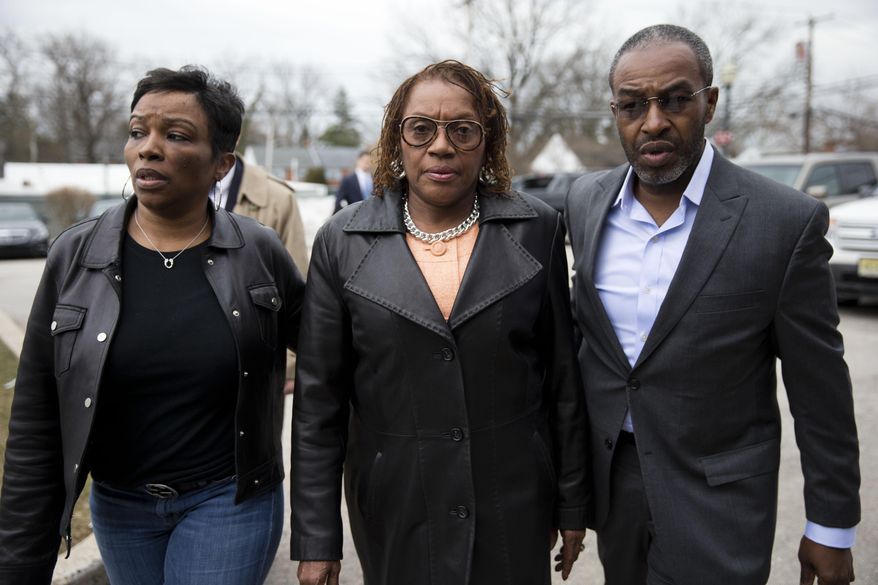 Pennsylvania state Sen. Leanna Washington, center, walks to the police station, Wednesday, March 12, 2014, in Abington, Pa. State prosecutors filed charges alleging Washington used her staff to organize an annual political fundraiser on taxpayer time, using taxpayer resources. (AP Photo/Matt Rourke)