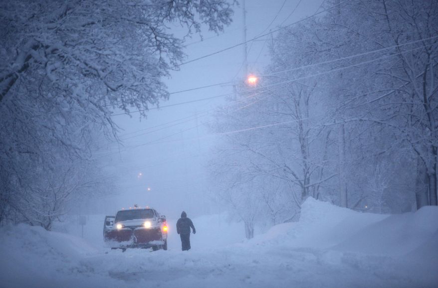 A snowplow arrives on Duke Street to clear driveways during a snow storm Wednesday, March 12, 2014, in Kalamazoo, Mich. (AP Photo/Kalamazoo Gazette-MLive Media Group, Mark Bugnaski) ALL LOCAL TV OUT; LOCAL TV INTERNET OUT