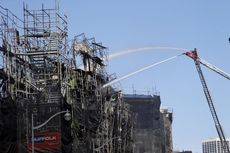 Firefighters continue to work a day after a structure fire in the Mission Bay neighborhood on Wednesday, March 12, 2014, in San Francisco. Hundreds of Mission Bay apartment dwellers chased from their homes by a huge fire at a building under construction are fortunate to have homes to return to, San Francisco Mayor Ed Lee said Wednesday, as firefighters put out hot spots and sought to determine the cause of the blaze. AP Photo/Marcio Jose Sanchez)