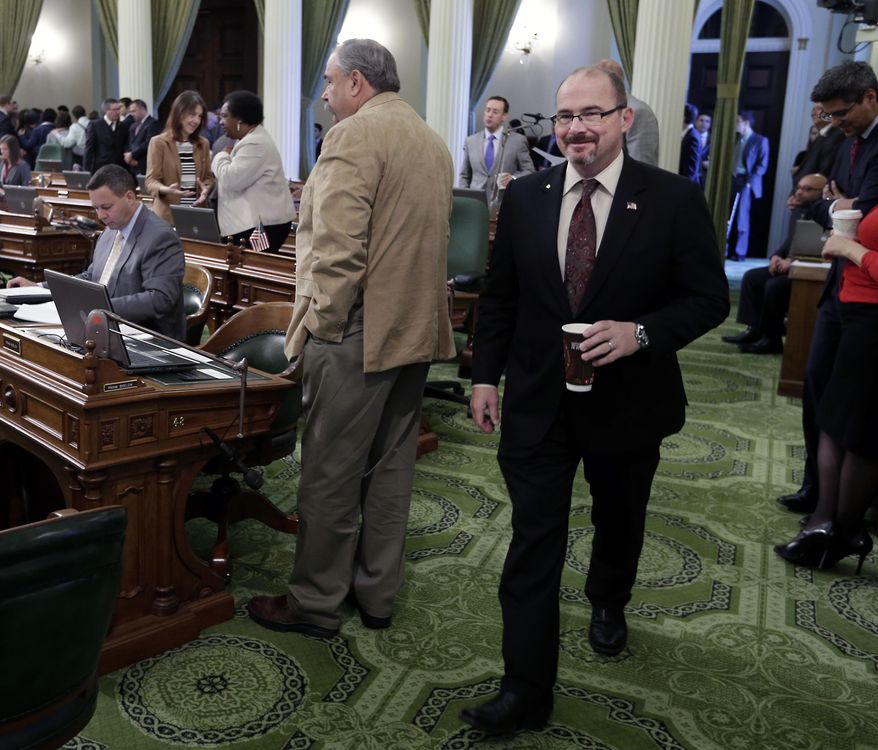 Assemblyman Tim Donnelly, R-Twin Peaks, walks to his desk in the Assembly chamber at the state Capitol in Sacramento, Calif., Thursday, March 13, 2014. Donnelly, a California gubernatorial candidate, said the sudden departure a day earlier of his campaign manager, Jennifer Kerns, will not hamper his push to energize activists during this weekend's GOP convention. (AP Photo/Rich Pedroncelli)