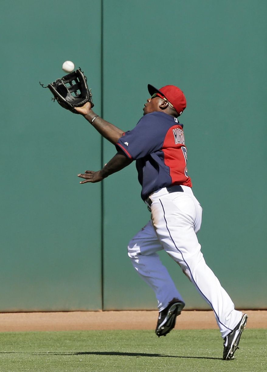 Cleveland Indians center fielder Nyjer Morgan makes a running catch on a deep fly ball hit by San Diego Padres&#x27; Tommy Medica in the fifth inning of a spring exhibition baseball game on Wednesday, March 12, 2014, in Goodyear, Ariz. (AP Photo/Mark Duncan)