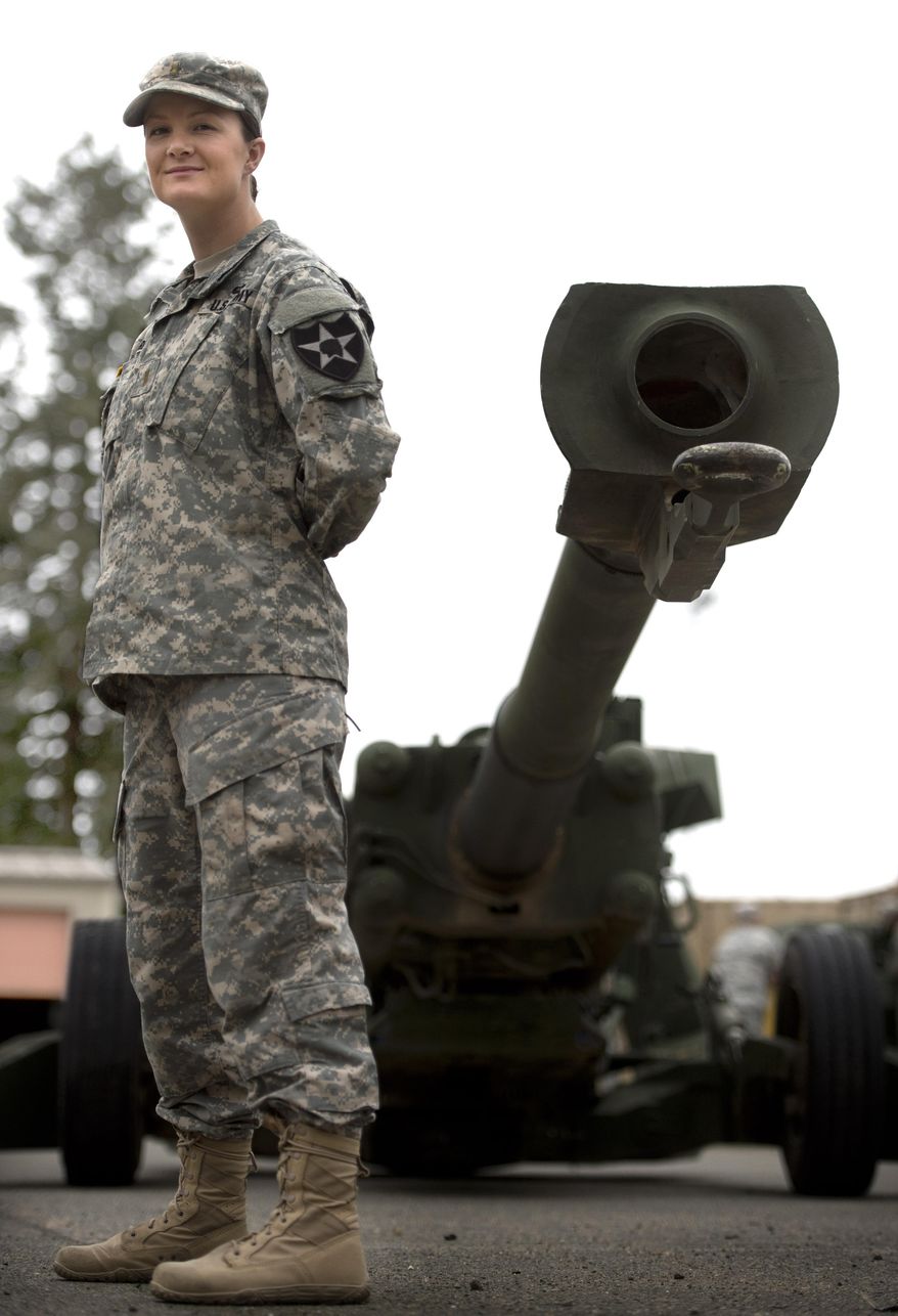 Lt. Taylor Cardosi stands next a howitzer weapon at Joint Base Lewis-McChord on March 5, 2014 in Washington. Cardosi is a front line fire direction officer in an artillery battery after combat roles are opening to women. Cardosi's posting at the base south of Tacoma was a small milestone in the Army's integration of female soldiers into front-line combat roles that had been barred to them, even as they took on increasing responsibilities in the Iraq and Afghanistan wars. (AP Photo/The News Tribune, Lui Kit Wong)
