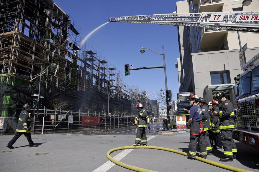 Firefighters continue to work a day after a structure fire in the Mission Bay neighborhood on Wednesday, March 12, 2014, in San Francisco. Hundreds of Mission Bay apartment dwellers chased from their homes by a huge fire at a building under construction are fortunate to have homes to return to, San Francisco Mayor Ed Lee said Wednesday, as firefighters put out hot spots and sought to determine the cause of the blaze. AP Photo/Marcio Jose Sanchez)