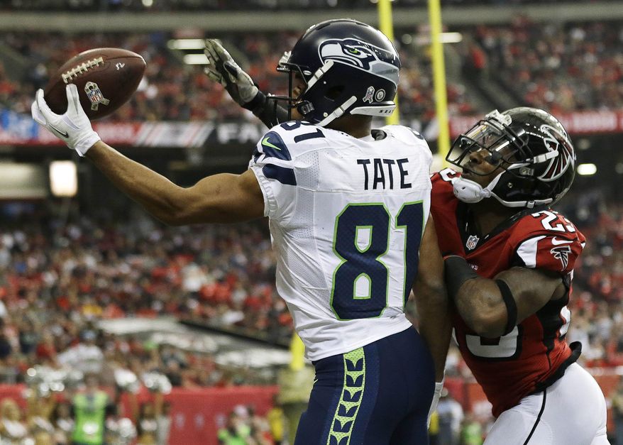 FILE - In this Nov. 10, 2013 file photo, Seattle Seahawks wide receiver Golden Tate (81) makes a touchdown catch against Atlanta Falcons cornerback Robert Alford (23) during the first half of an NFL football game in Atlanta. Tate traveled to Detroit on Tuesday night, March 11, 2014, to meet with the Lions on Wednesday. (AP Photo/John Bazemore, File)