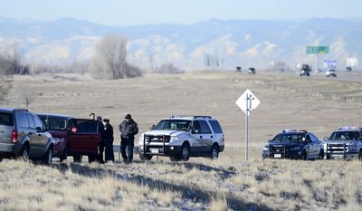 Officers from Colorado State Patrol, Brighton Police and Adams County Sheriff&#39;s Department look over the car, second from left, in Brighton, Colo., Wednesday, March 12, 2014, that was allegedly stolen by Ryan Stone earlier in the day in Longmont, Colo. Stone is suspected of stealing the SUV with a 4-year-old child inside and then carjacking two other vehicles during the chase near Denver on Wednesday before he was apprehended. (AP Photo/The Daily Camera,  Mark Leffingwel) NO SALES, MAGS OUT, TV OUT