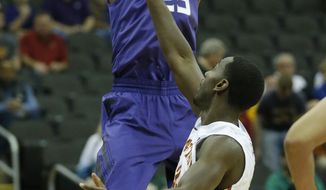 Kansas State guard Wesley Iwundu (25) shoots over Iowa State forward Dustin Hogue (22) during the first half during the first half of an NCAA college basketball game in the quarterfinals of the Big 12 Conference men&#x27;s tournament in Kansas City, Mo., Thursday, March 13, 2014. (AP Photo/Orlin Wagner)