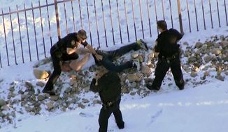 In this image taken from video provided by CBS-4 TV Denver, Ryan Stone, 29, is apprehended by police in Lone Tree, Colo., on Wednesday, March 12, 2014. Stone, suspected of stealing an SUV with a 4-year-old boy inside, carjacking two other vehicles and seriously injuring a state trooper was arrested Wednesday after police tracked him, and at times chased him, around the Denver area during morning rush hour.  (AP Photo/CBS-4 TV Denver)