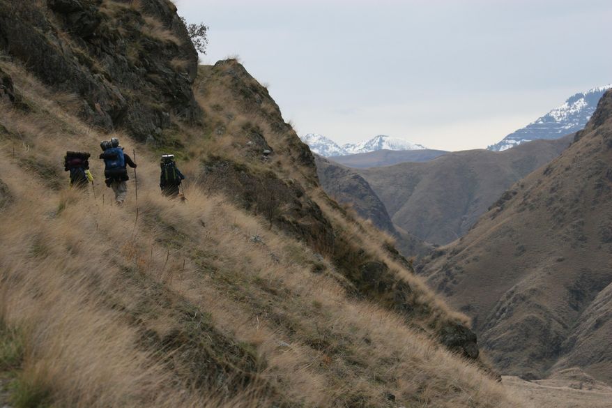 Backpackers hike along the Snake River Trail in Hells Canyon on the Idaho side of the canyon heading toward Kirkwood Ranch in this undated photo. During spring break, it’s winterlike or springlike somewhere in Idaho because of the states' cold mountains and mild canyons.(AP Photo/Idaho Statesman, Pete Zimowsky)
