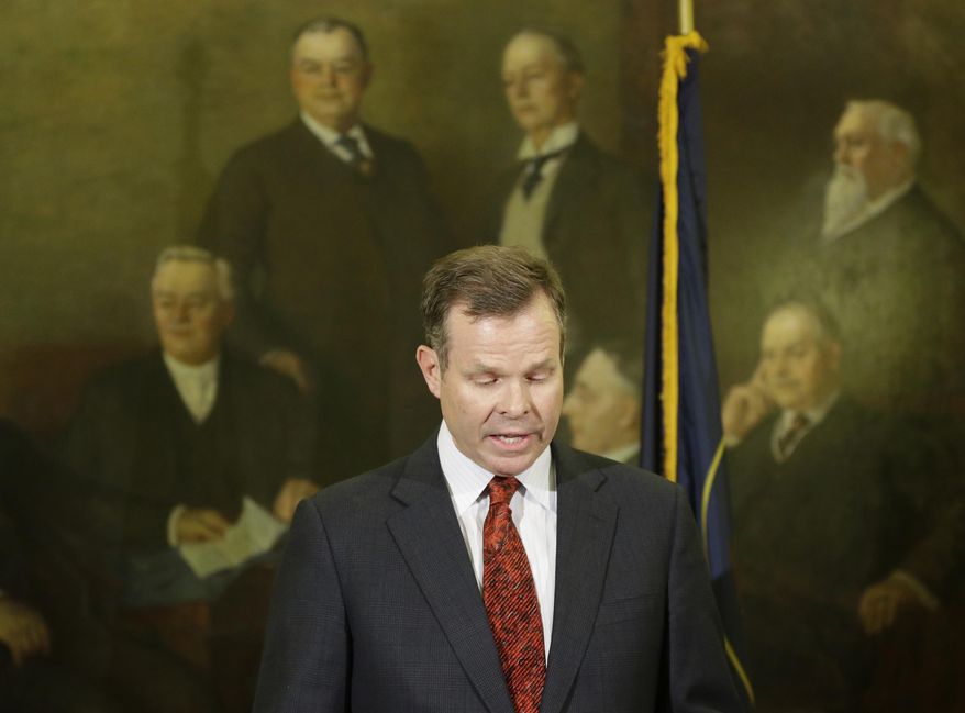File - In this Nov. 21, 2013, file photo, Utah Attorney General John Swallow looks down during a news conference announcing that he is stepping down amid multiple investigations of bribery and misconduct, at the Utah State Capitol, in Salt Lake City. A House committee that investigated Swallow has released a final report of its findings Wednesday, March 12, 2014. The report came as the Utah State Bar announced it's been investigating Swallow for over a year after initial allegations against him appeared in the media. (AP Photo/Rick Bowmer, File)