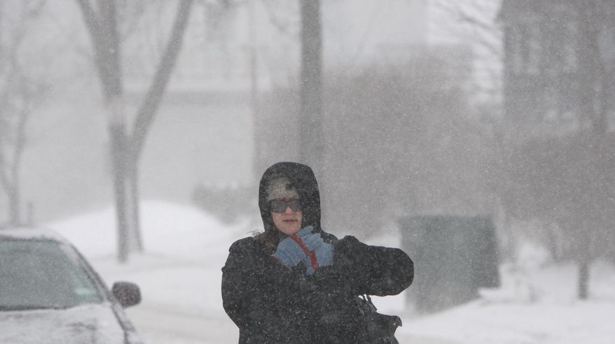 Strong winds and snow made for brutal walking conditions for even the heartiest along Goodman Street, Wednesday, March 12, 2014 in Rochester, N.Y. Many business and government offices closed early ahead of a winter storm. (AP Photo/Democrat & Chronicle, Shawn Dowd) MAGS OUT; NO SALES