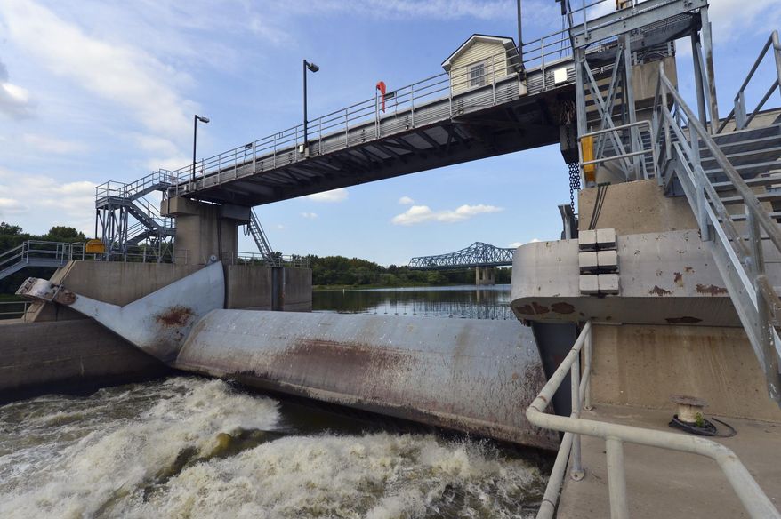 This Sept. 5, 2013 photo shows the 75-year-old lock and dam in Peoria, Ill. Illinois lawmakers say congressional negotiators are moving toward an agreement on legislation authorizing improvements to shipping channels, flood protections and other waterways projects around the country. Among the Illinois projects are the lock and dam in Peoria and the Olmsted Lock and Dam between Illinois and Kentucky. (AP Photo/Journal Star, Fred Zwicky)